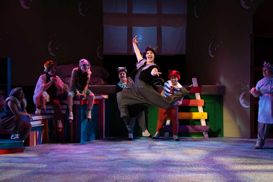 A Converse Theatre and Dance student leaps in the air during a performance.