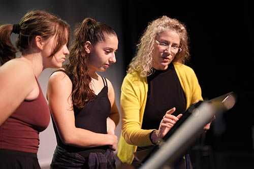 A faculty member teaches Converse theatre students.