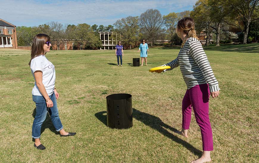 Students playing with frisbees