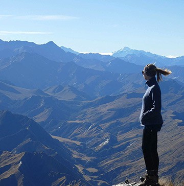 Image of Stephanie standing on a mountaintop in New Zealand