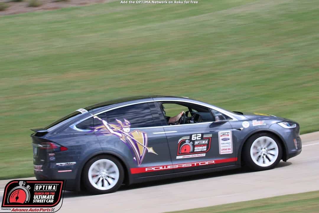 A Tesla with the Valkyrie on the side, driven by alumna Karen Thomas