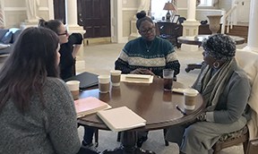 Students interview older adults while researching the production