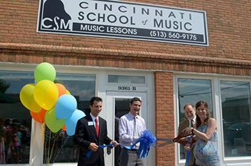 Backer family has cuts ribbon outside new piano studio