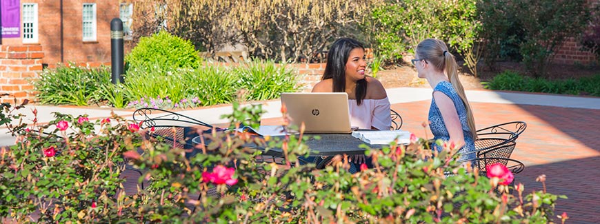 Two transfer students talk outdoors
