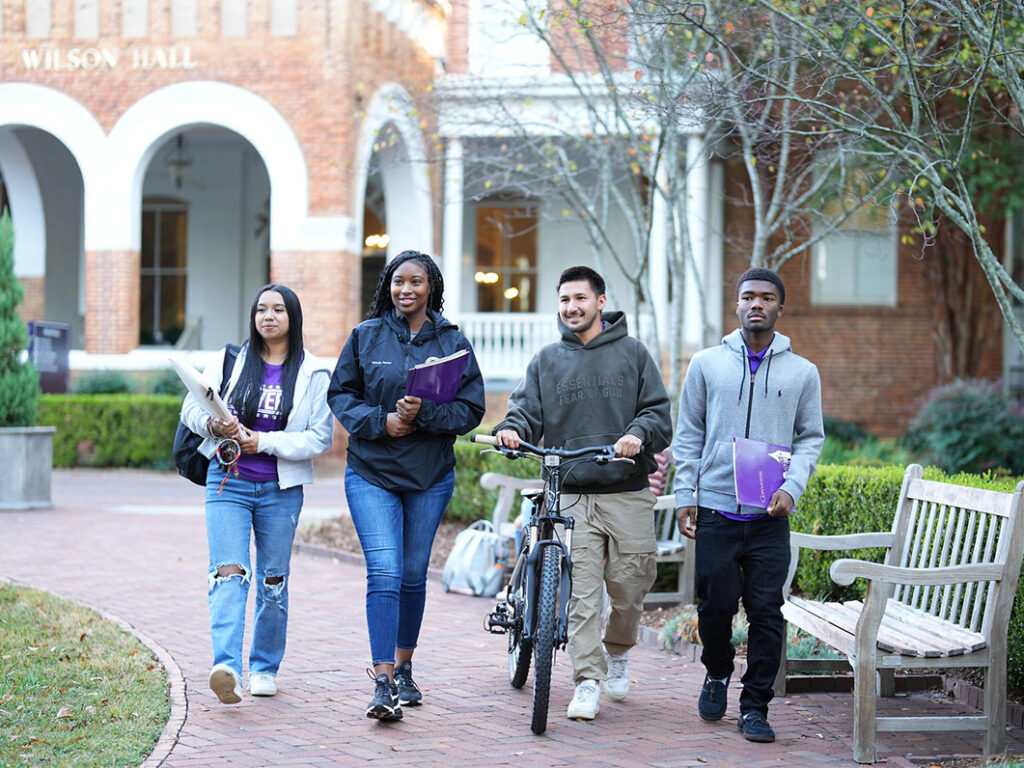 Smiling Converse students walk on campus