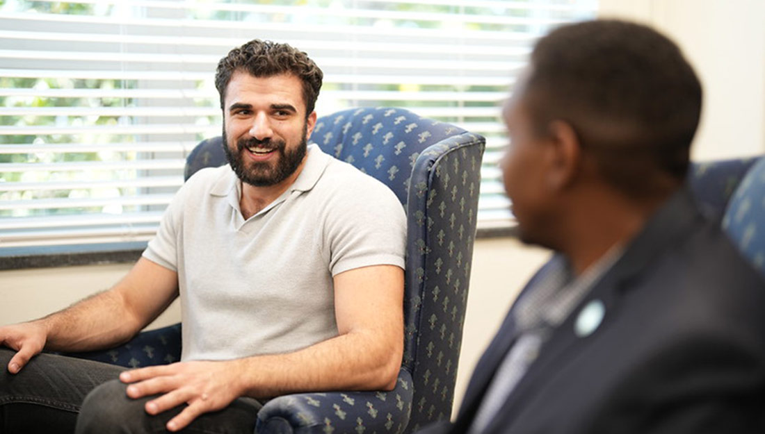 A graduate student attends an information session