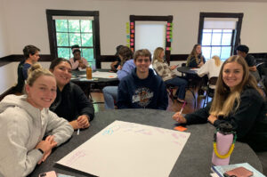 Converse Sullivan Fellows write ideas on a whiteboard.