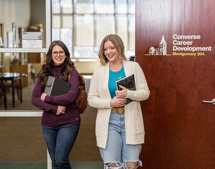 Adult Converse students walk out of the career center office.