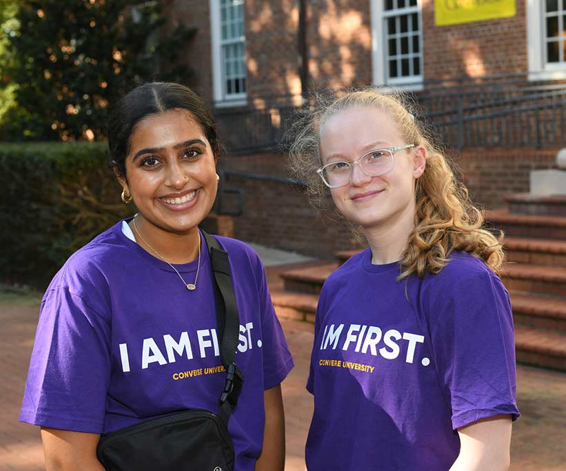 Two Converse first-generation students smiling on campus.