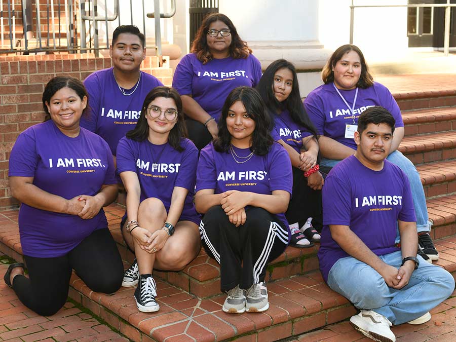 Converse first-gen students sitting on campus