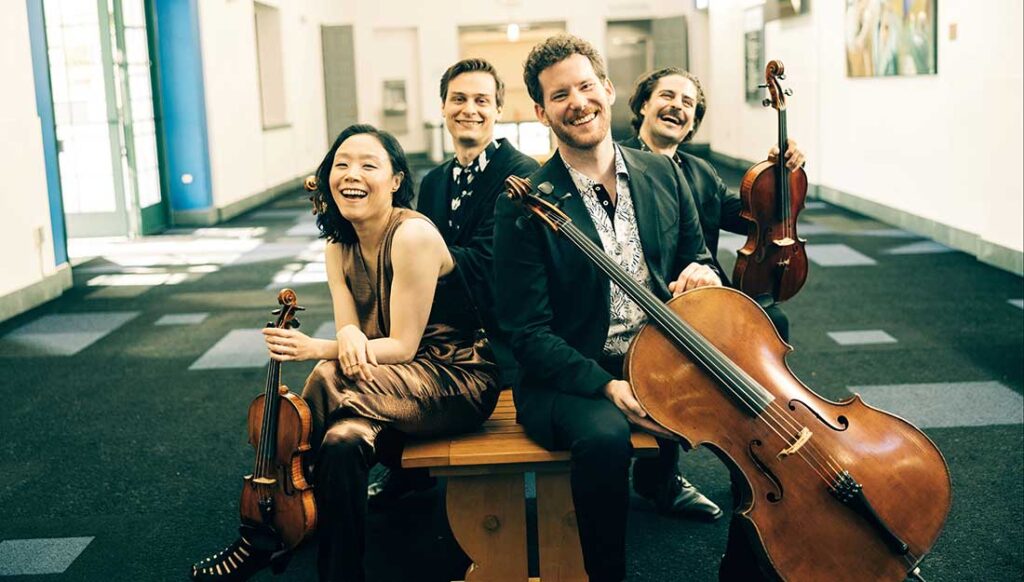 Group photo of the Tesla Quartet with their instruments