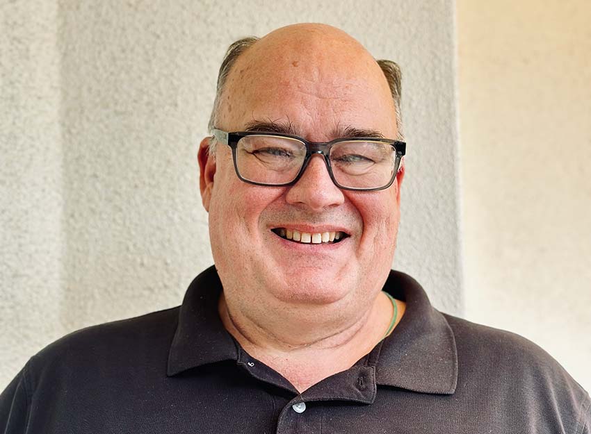 John Roche smiling outdoors