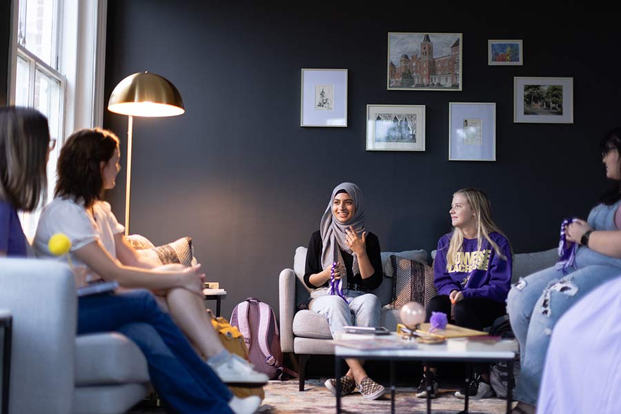 A group of Converse College for Women socialize in a campus lounge.