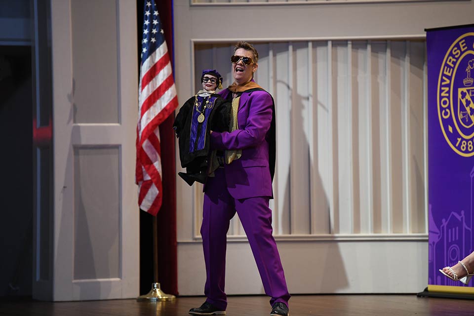 Meg Tominaga stands on the Twichell stage with the ventriloquist doll of President Hopkins.