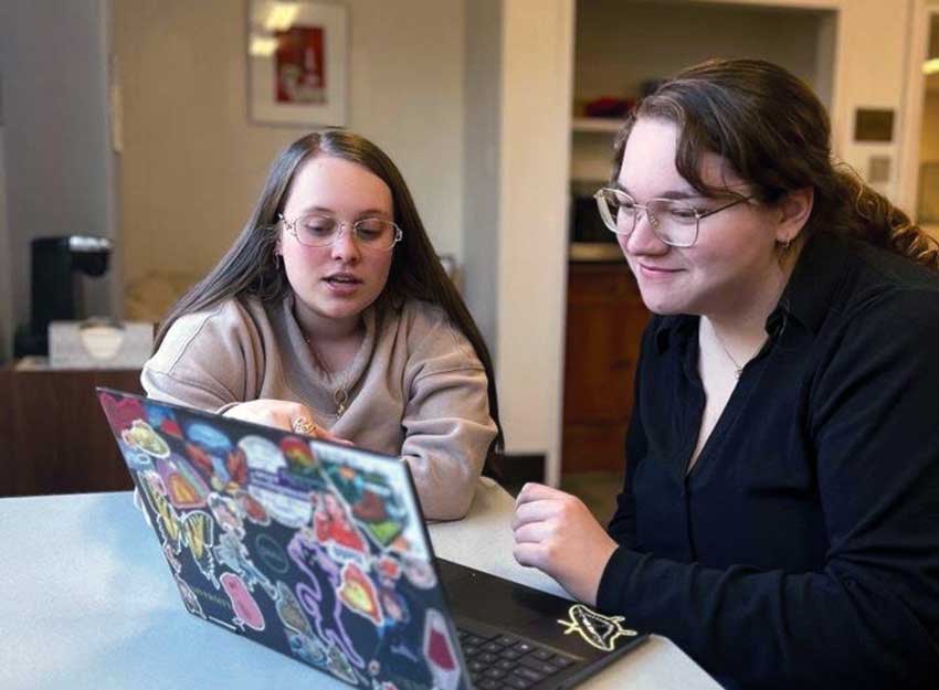 A writing center peer works with a Converse student on a paper for class.