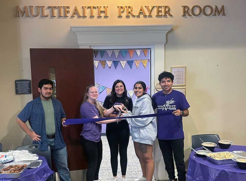 Members of the Converse community stand in front of the Multifaith Prayer Room cutting the ribbon for its grand opening.