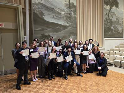 Converse Model Programs participants holding up their award award certificates after the conference.