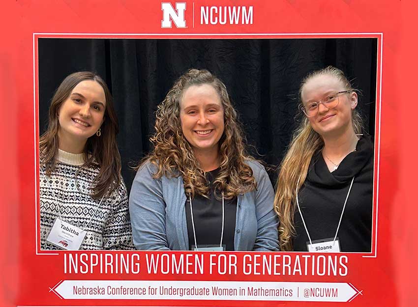 Dr. Mangum stands between Sloane Kinley and Tabitha Merrithew in frame that reads. 'Inspiring Women for generations."