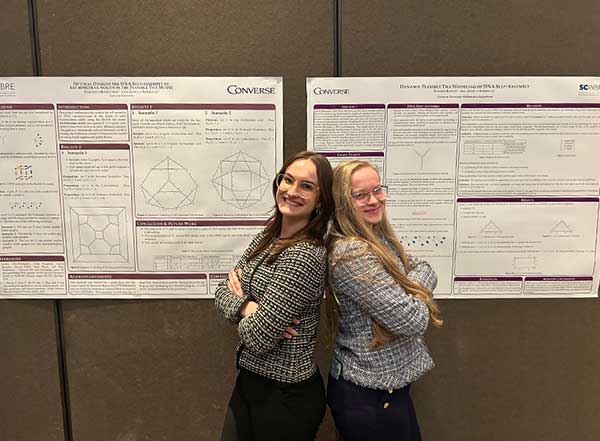 Sloane Kinley and Tabitha Merrithew stand in front of their posters at the 2025 Nebraska Conference for Undergraduate Women in Mathematics