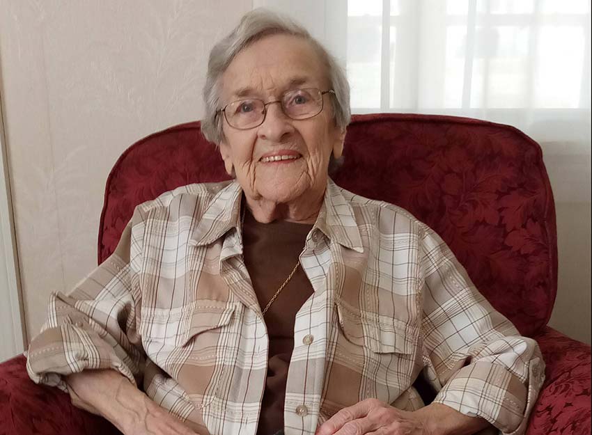 Janis Dengler smiles while sitting