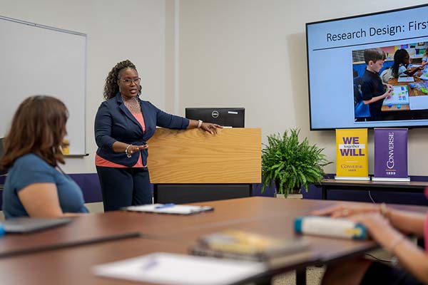 A Converse University EdD student presents their dissertation to a group.
