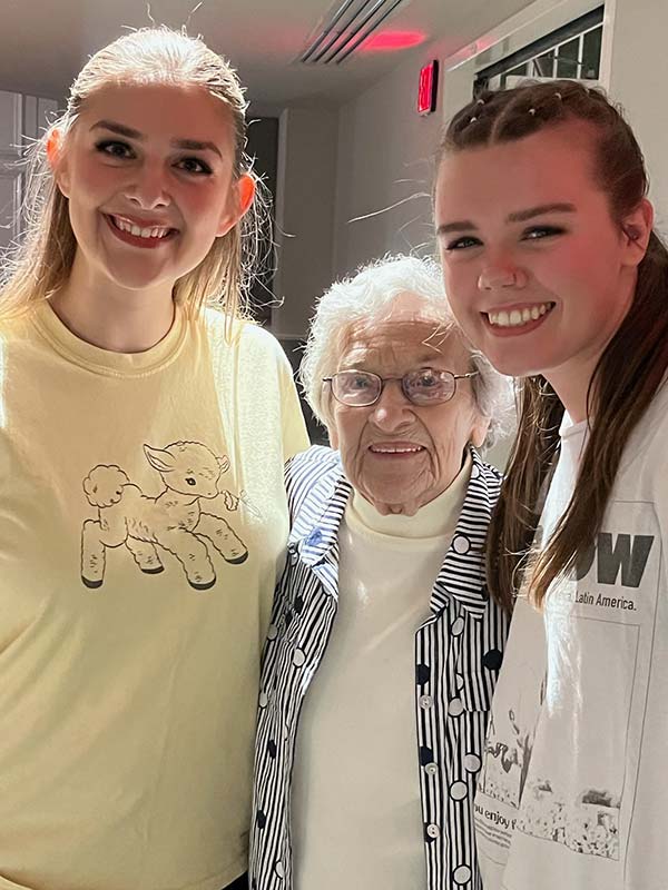 Janis Dengler stands with two Converse Dance students.