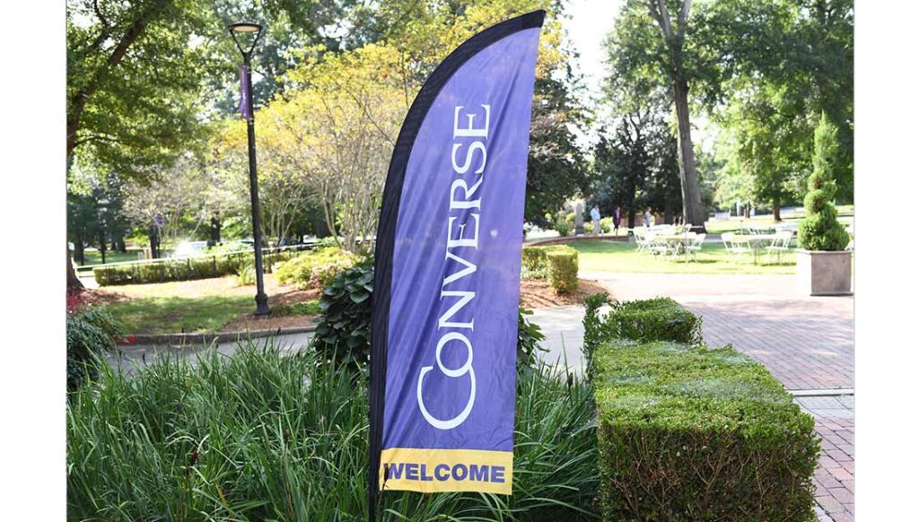 A flag on campus that reads "Converse welcome."