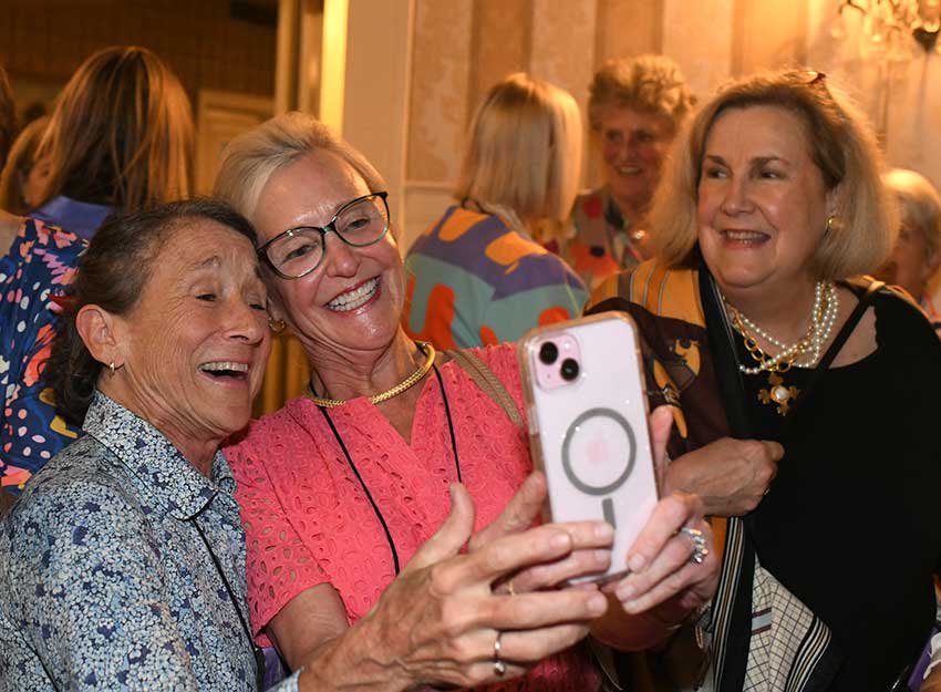 Members of the Class of 1975 take selfies while at Converse Reunion