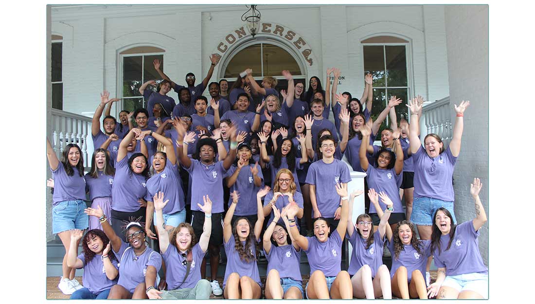 New Converse students cheer and smile on the front porch of the University.
