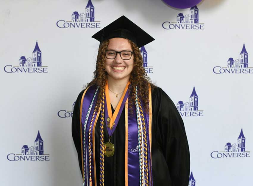 Formal photo of Chloe Cleland in her graduation cap and gown.