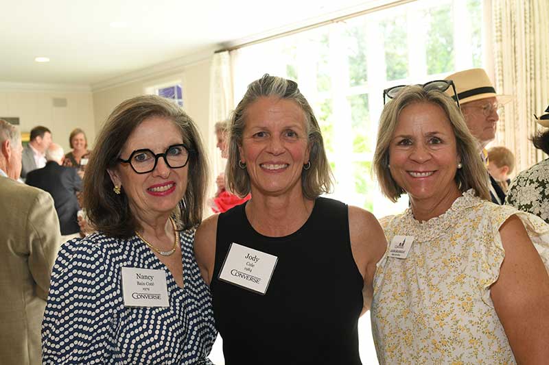 Donors smile with a Converse staff member at the 2025 Donor Garden Party.