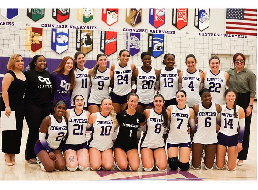 A team photo of the Converse University volleyball team and their coaches.