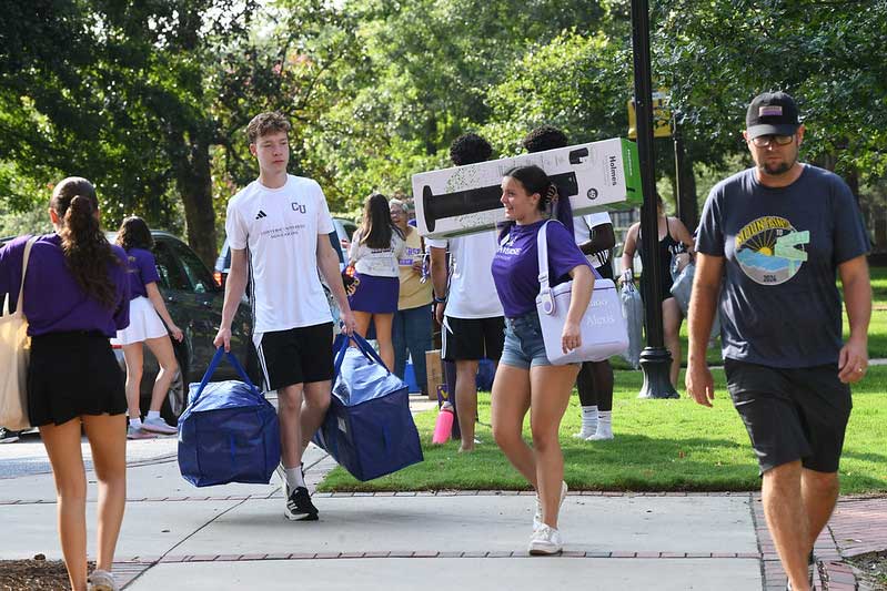 Converse students and volunteers move items across campus during move-in week.