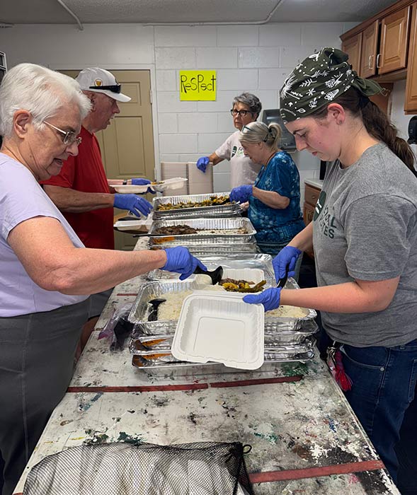 Ashleigh works with others in the kitchen at Equal Plates in Asheville.