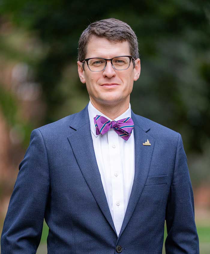 Official portrait of Converse University President Boone Hopkins with a serious expression.