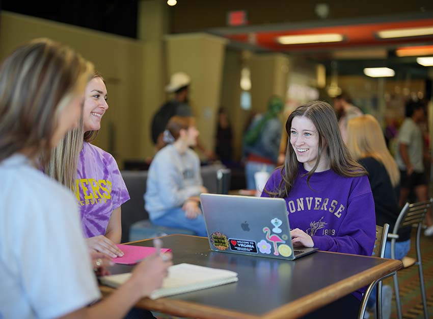 A group of students socialize in the lounge.