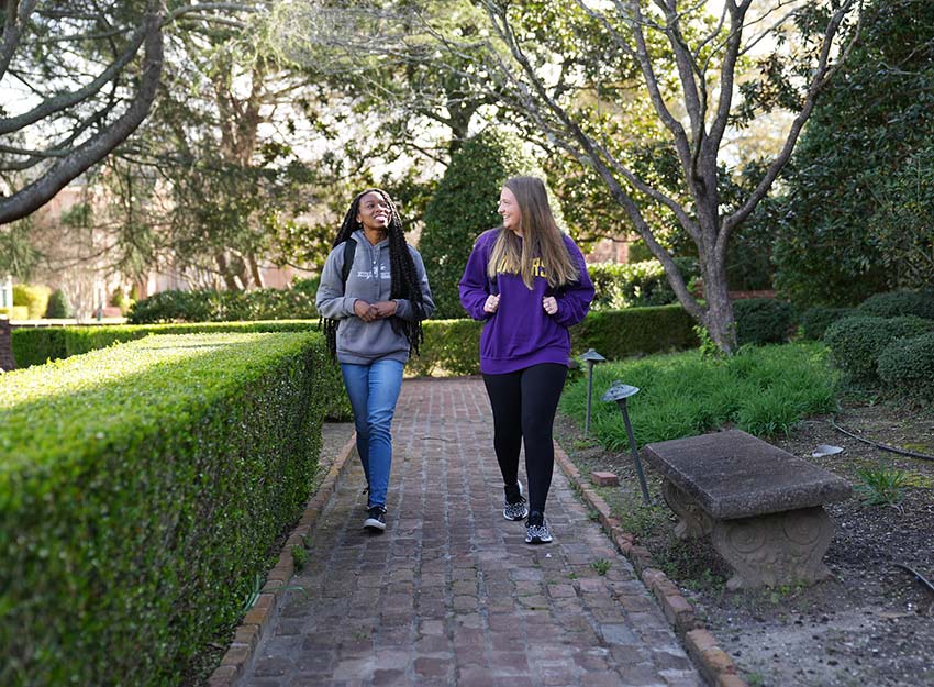 Converse students walk and talk on campus.