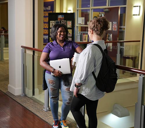 LaShaunna talks with another student in Converse University's student center.