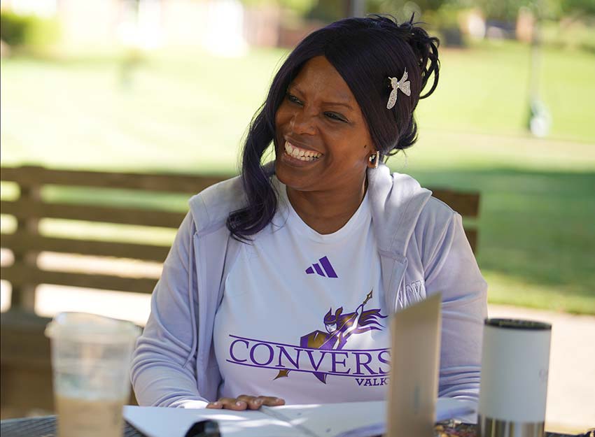 Gwen Fuller smiles while wearing a Converse University shirt