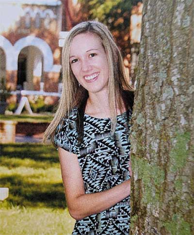 Anna Robinson '16 standing beside a tree in front of WIlson Hall
