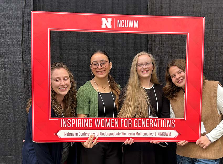 Math faculty and students in a large frame that reads, "Inspiring Women for Generations".