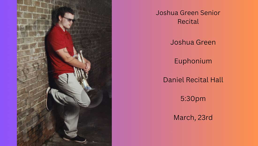 Joshua Green standing against a brick wall