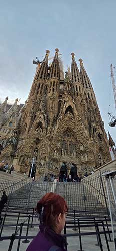 A Converse study travel student stands in front of a massive church.