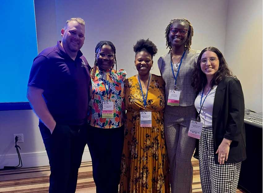Converse MMFT faculty and staff at a conference