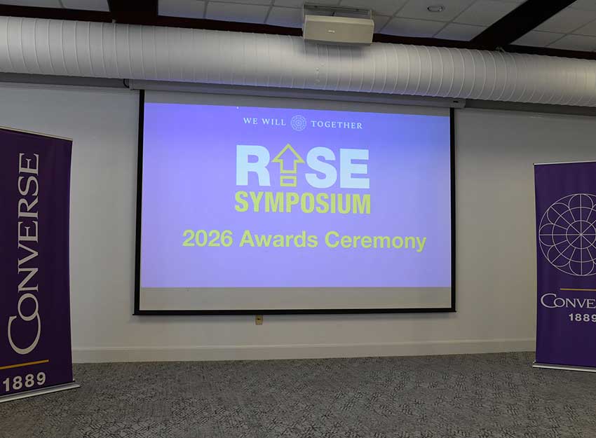 A large screen displays the words: RISE Symposium 2026 awards ceremony