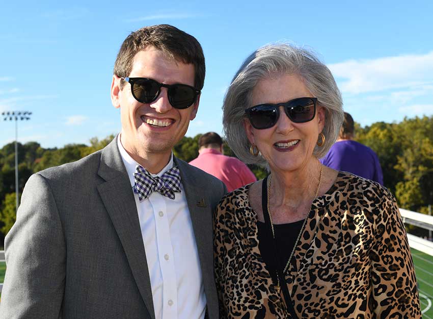 Melissa stands with President Hopkins at a Converse event.