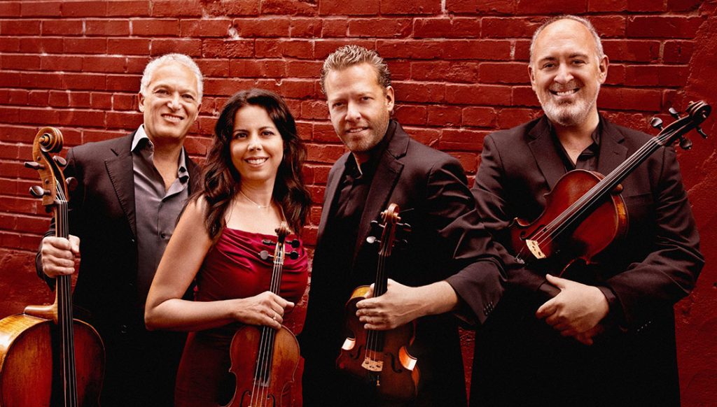 Members of the PACIFICA QUARTET pose with their instruments.