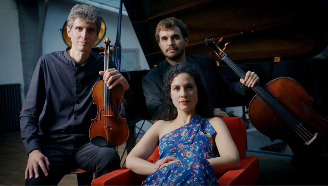The trio members pose with their instruments.