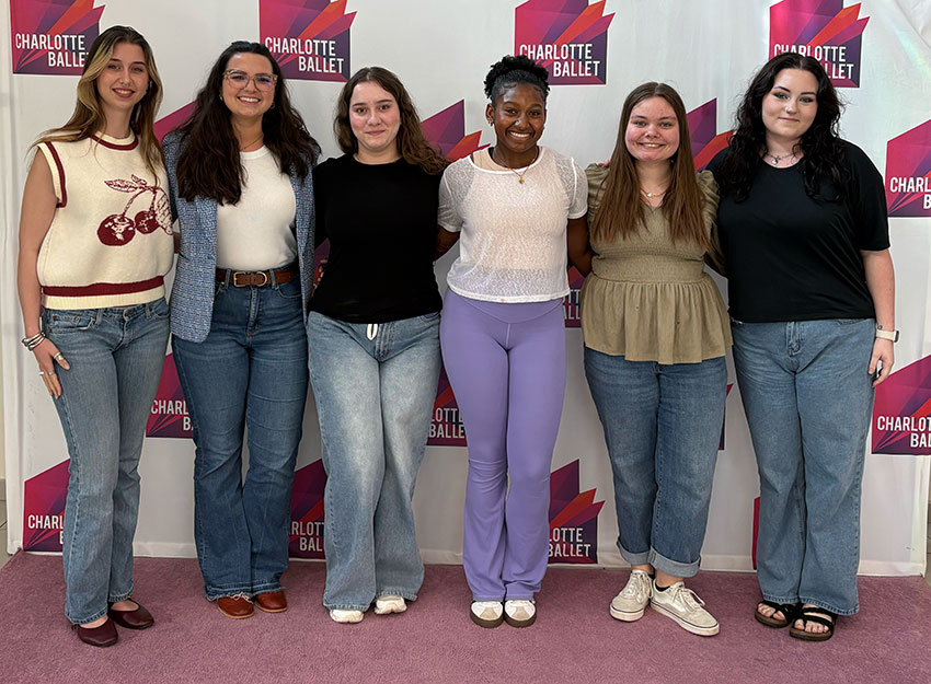 Converse students stand in front of a Charlotte Ballet backdrop