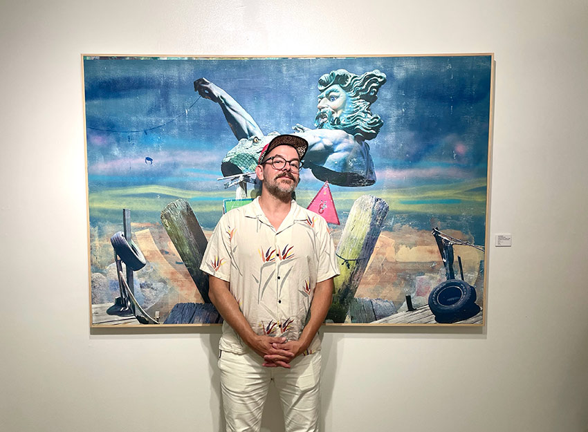 Professor Blanchard stands in front of one of his works of art.
